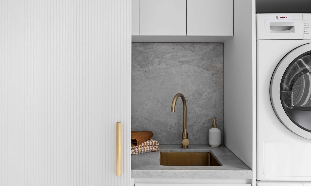 Euro Laundry Renovation South Melbourne Interior Design Minimalist Home Natural Stone Benchtop and Splashback Brushed Brass Fittings